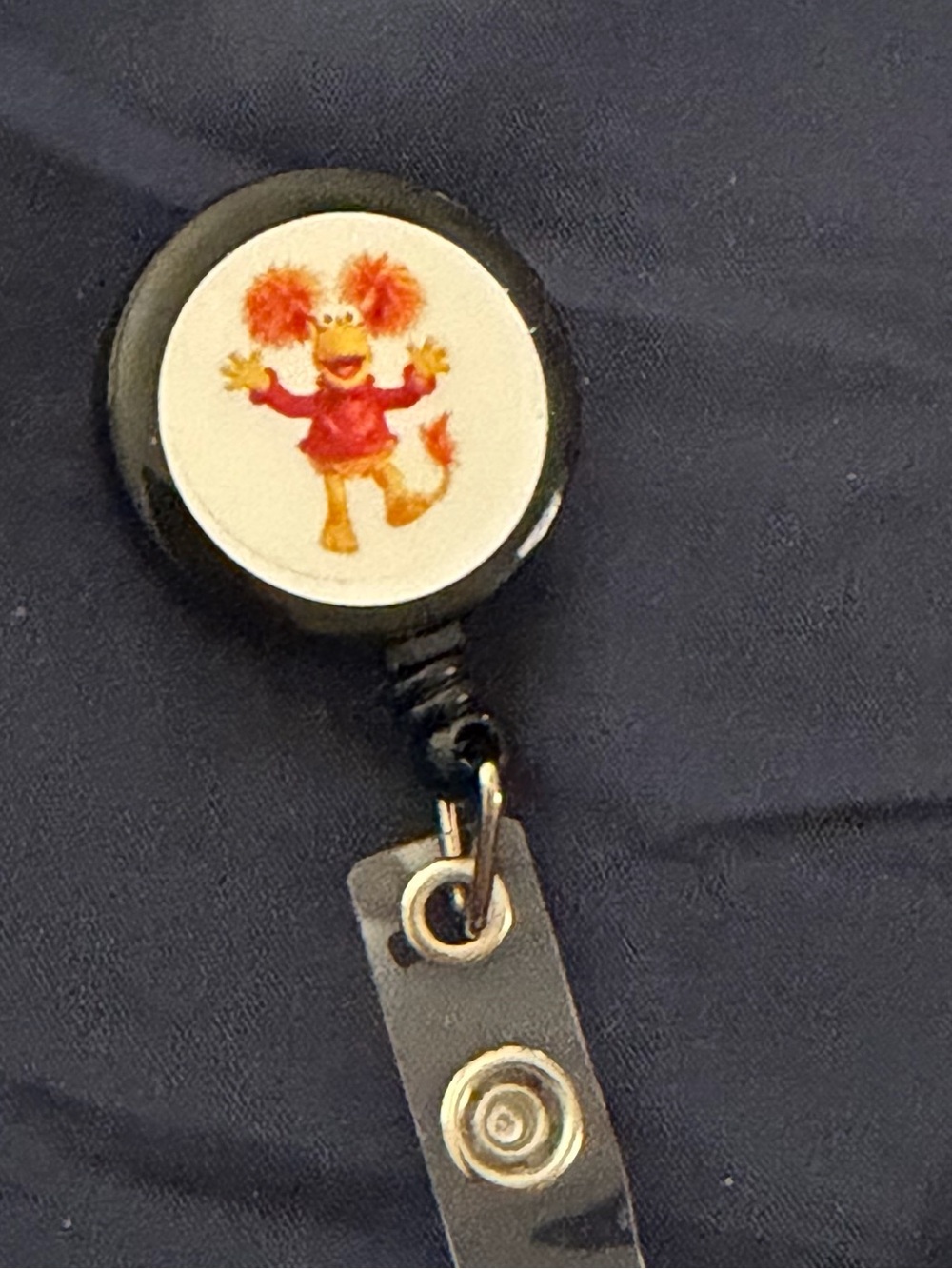 Black Badge Reel with Orange Character Print - Accessories